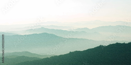 A serene morning sunrise casts a golden glow over a misty mountain landscape, where a dense forest and rolling hills fade into the scenic fog and dramatic clouds under a vibrant twilight sky