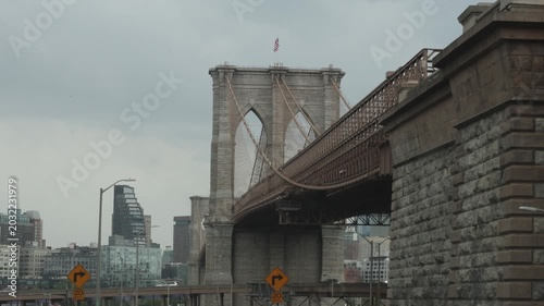 car driving over under brooklyn bridge with manhattan new york city skyline view traffic pov highway suspension road crossing nyc travel tourism drive