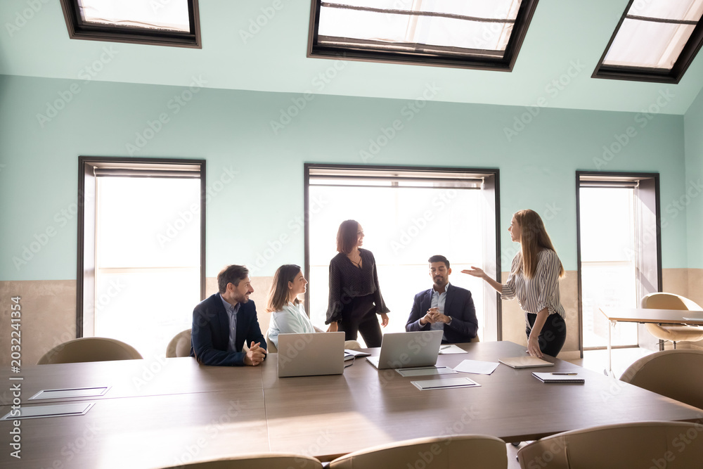 Fototapeta premium Group of diverse staff members having corporate meeting discussion in conference room. Business communication, team collaboration during teamwork, strategy planning, training, decision making concept