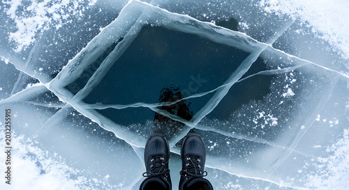 Person standing on frozen cracked ice with dark water visible in the center of the cracked ice ai generated