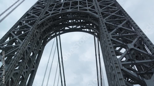 point of view of car driving over george washington bridge between fort lee new jersey and manhattan york heights (sunset night time cloudy suspension bridge)