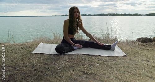 Engaging in a Relaxing Yoga Practice by the Beautiful and Serene Lake in Natures Embrace