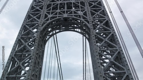 point of view of car driving over george washington bridge between fort lee new jersey and manhattan york heights (sunset night time cloudy suspension bridge)