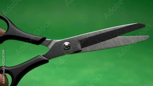 Close up of scissors on green background cutting and crafting concept