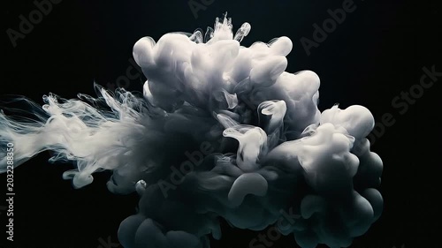 Smoke billows and rises rapidly in a dark environment with clouds