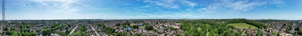 Fototapeta premium High Angle Panoramic View of Residential Homes at Luton City During Hot Weather and Sunny Day. Urban Drone Flight Above Urban City Streets of British City and Town of England Great Britain.