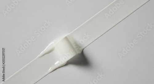 Diagonal Line Interrupted - A Twisted Knot of White Adhesive Tape on a Minimalist Surface.