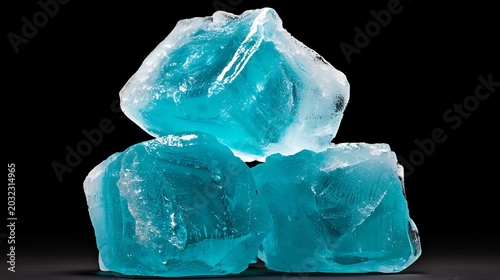 Three Teal Ice Cubes on Black Background