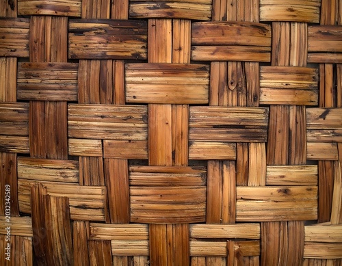 A close-up of woven wooden strips in a crisscross pattern