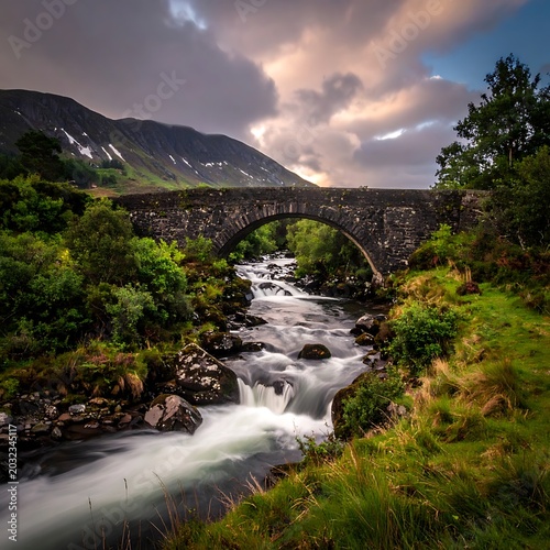 A serene stone bridge spans a fast-flowing river in a mountainous landscape