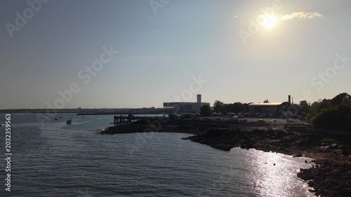 Aerial view of Galveston Island coastal town and Historic Pleasure Pier amusement park on ocean shoreline bright sunny day Texas