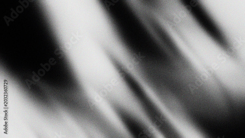 Abstract grainy gradient background with monochromatic black and white silk folds texture
