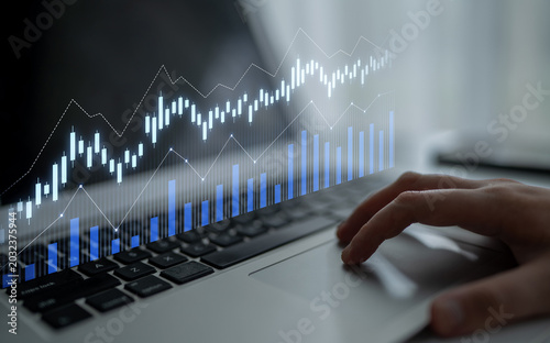 Obraz na plátne A professional workspace featuring a laptop displaying data analysis with graphs and charts, highlighting trends and growth for financial success
