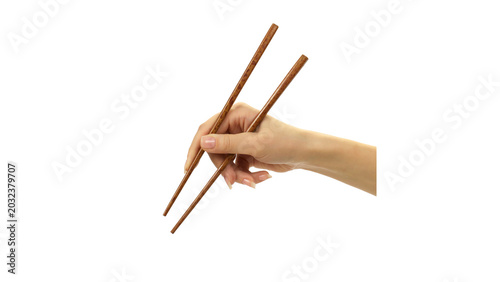 Schilderij op canvas Female hand holding wooden chopsticks isolated on transparent background