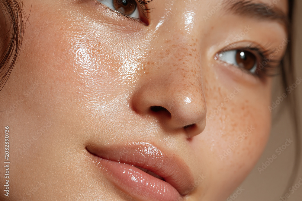 Fototapeta premium Glowing close up of Japanese skin with soft light highlighting dewy complexion, freckles, and smooth texture conveying natural radiance and gentle mood