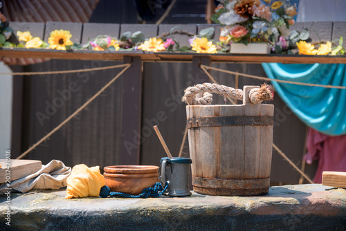 Foto Traditional wooden and ceramic vessels are displayed on a weathered stone surfac