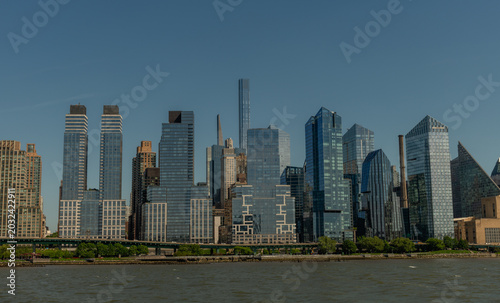 Scenic panoramic Upper West Side shore vista on a sunny summer day viewed from a boat, New York City 