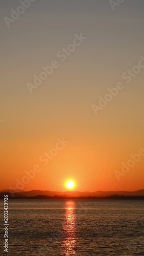 nature sky breathtaking golden sunset over a calm ocean, with the entire sky and water bathed in brilliant shades of yellow and orange. Streaky clouds enhance the dramatic display	