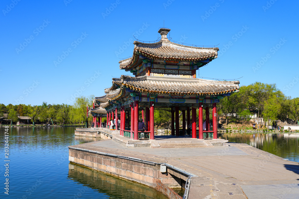 Fototapeta premium Traditional wooden pavilions and stone bridges with water reflections at the scenic lake area of Chengde Mountain Resort, Hebei, China