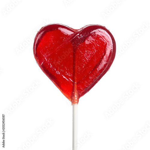 Close-up of glossy red heart-shaped lollipop on white background with soft light