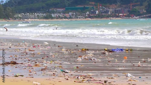 Tropical shoreline overwhelmed by disgusting trash pollution and ocean debris Thailand.