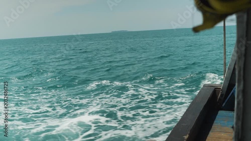 Waves crashing against boat on ocean