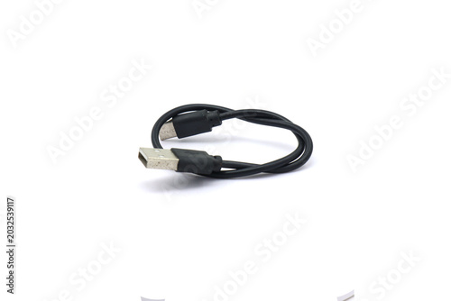A black USB cable on a white background. A USB cable for data transfer.