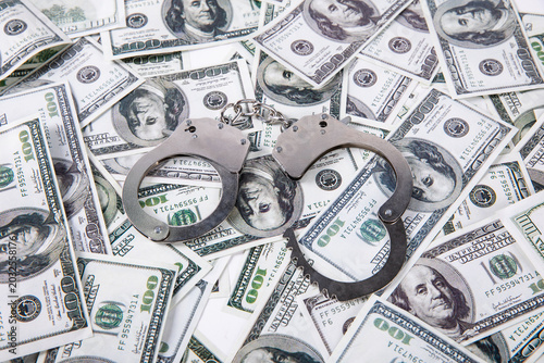 Tableau sur toile Handcuffs on US Dollar Bills - Financial Crime Concept