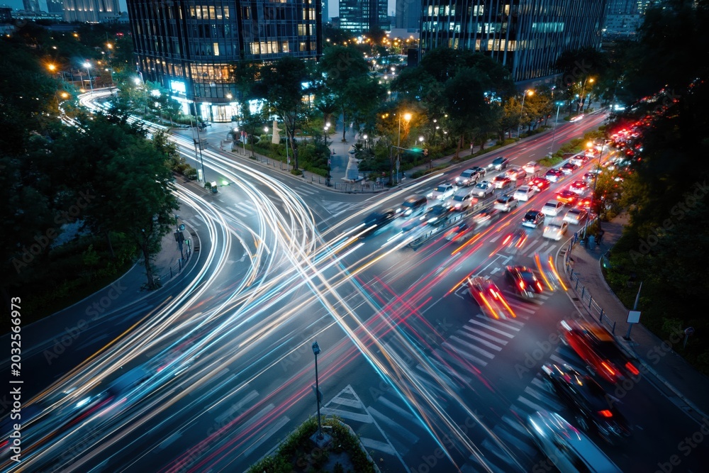Fototapeta premium Captivating long exposure of a busy city intersection at night with blurred car light trails