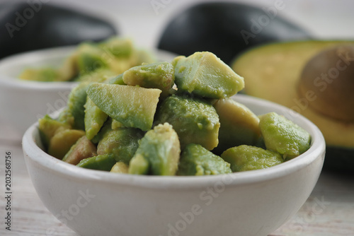 Chopped avocado pieces in a small bowl on a table