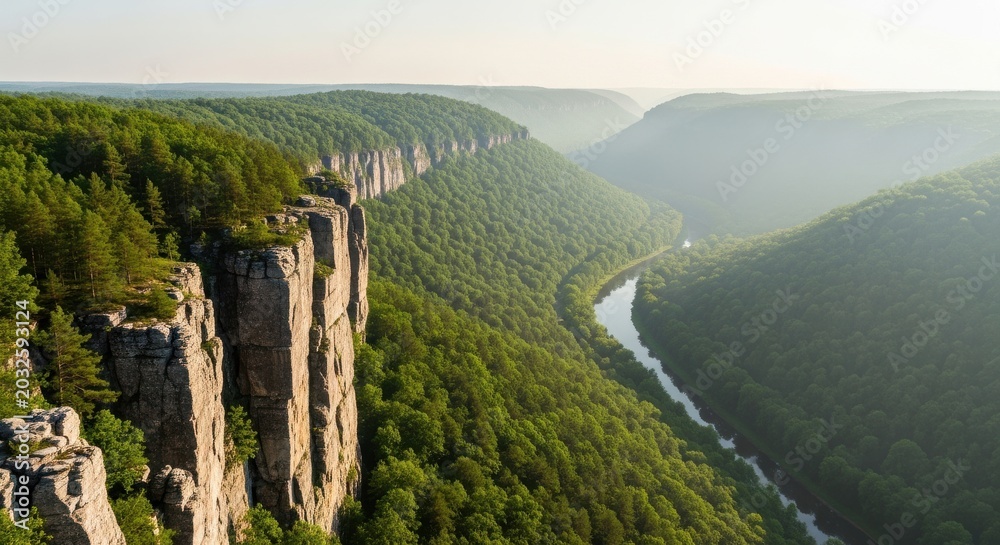 Obraz premium Steep Rocky Cliffs Overlooking Lush Green Valley and Winding River
