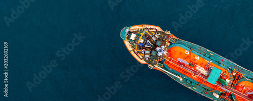 Aerial view Gas ship tanker vessel loading and unloading in oil terminal station refinery, Global business import export logistic transport sea freight cargo gas tanker ship, Gas tanker ship at sea.