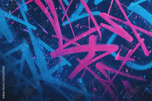 Abstract graffiti art with intersecting neon pink and blue spray-painted lines on a dark background