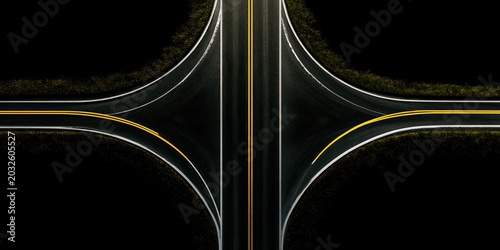 Overhead view of a symmetrical, dark highway interchange at night