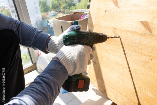 Percussion drilling work with green power tool in residential repair