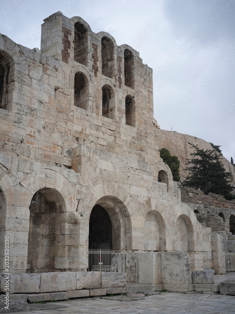 Naklejka premium Greece, Athens. Ancient stone building facade with arched windows, historic architecture, cultural heritage, old ruins, travel destination.