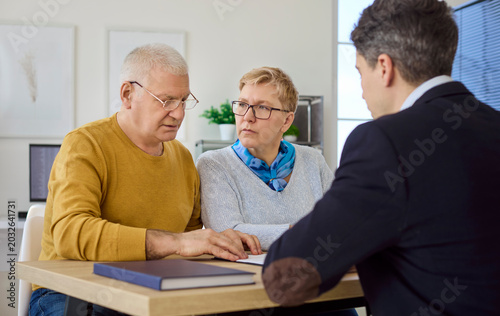 Fotografie Senior couple in consultation with advisor