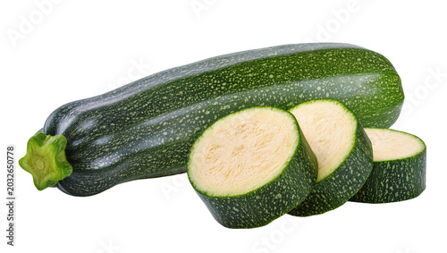 Whole green zucchini with three slices showing pale flesh and seeds