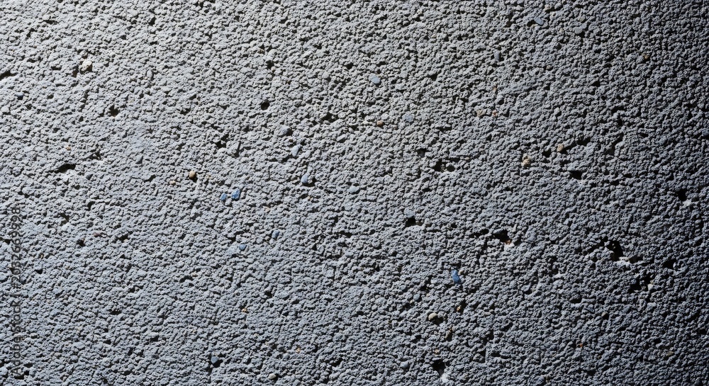 Obraz premium Close up of a textured concrete surface with subtle shadows.