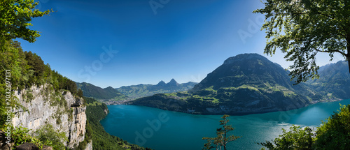 large Panorama of the cradle of Switzerland in summer with blue sky, featuring Lake Waldsthal, Rütli Meadow, and the Mythen mountain.