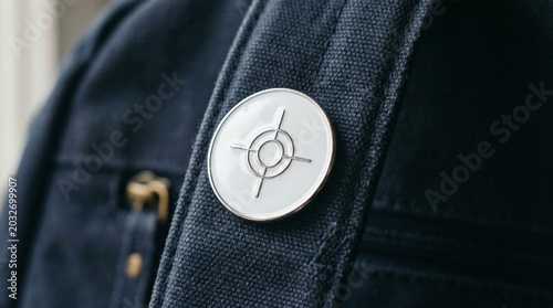 Realistic image of a white enamel pin badge with simple circle design