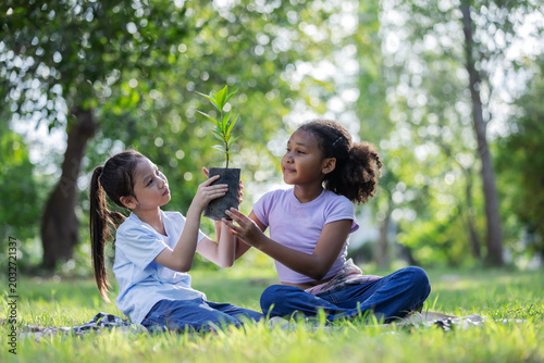 Multicultural Children Holding Young Tree Together for Eco Education and Sustainability Concept