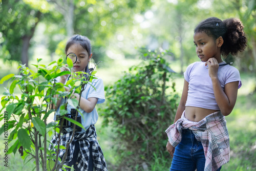 Multicultural Children Exploring Bushes and Discovering Nature During Eco Education Activity