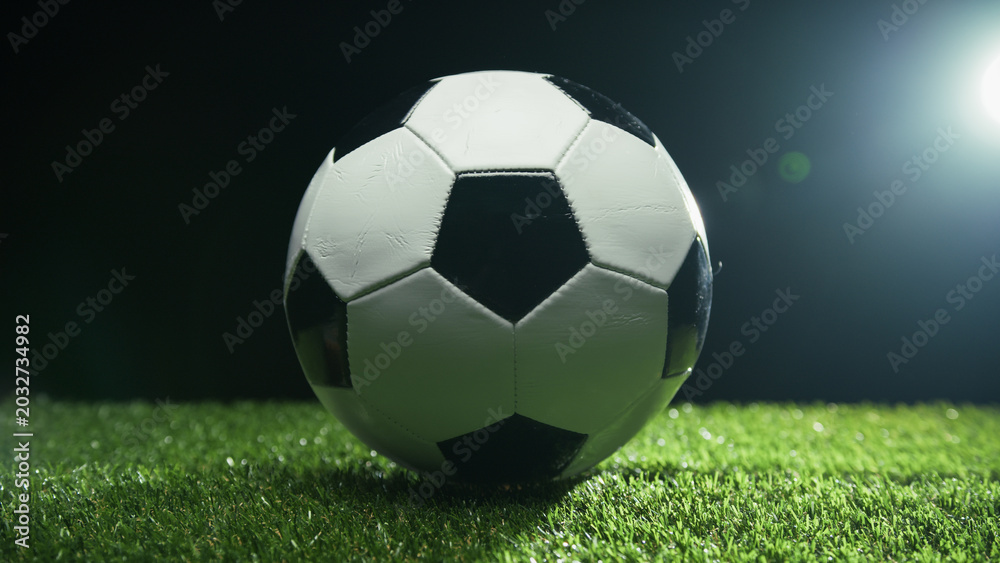 Fototapeta premium Soccer ball rolls on the grass in the green field ready in the stadium