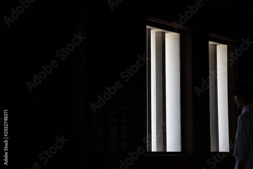 man looking out window