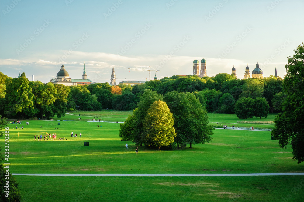 Fototapeta premium Munich, Germany skyline from Englischer Garten with Frauenkirche, Neues Rathaus, Theatinerkirche, Bavarian State Chancellery and park lawns