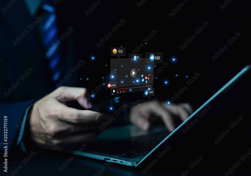 Fototapeta premium Businessman using smartphone with social media icons, likes, comments, and shares, representing digital marketing, online communication, engagement, social networking, and mobile technology.