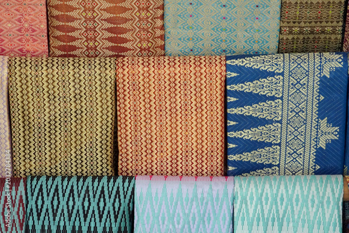 Colorful traditional handwoven fabrics on display.