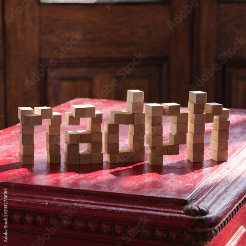 the word nadph is made of wooden cubes on a red table