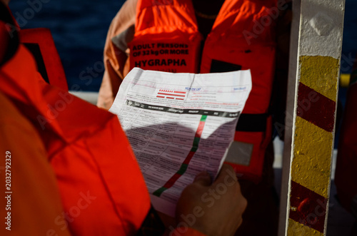 The emergency drill on board of the offshore support vessel. Chief officer is challenging the crew knowledge of their emergency duties as per the muster checklist. Douala, 